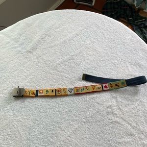 Cub Scout belt with 17 loop slider awards. Size small.